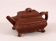 A CHINESE YIXING CLAY TEAPOT, with a moulded body of foliage, the base with an impressed mark,