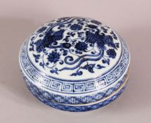 A CHINESE MING STYLE BLUE & WHITE PORCELAIN BOX & COVER, decorated with phoenix and lotus, the