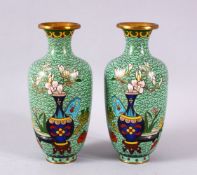 A PAIR OF CHINESE CLOISONNE APPLE GREEN GROUND VASES - each with a green ground with native