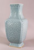A CHINESE SKY BLUE GLAZED MOULDED PORCELAIN VASE, decorated with moulded panel decoration in archaic