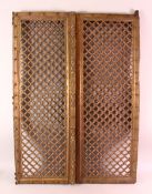 A PAIR OF INDIAN CARVED ROSEWOOD WINDOW SHUTTERS, with carved openwork panels, each section,