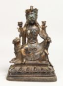 A BRONZE SEATED GOD FIGURE with dog, 8.5ins high.