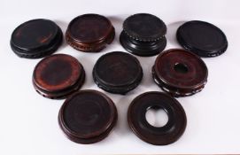 A MIXED LOT OF 12 CHINESE CARVED HARDWOOD STANDS - each of varying size, style and timber, the