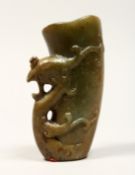 A CHINESE CARVED JADE LIBATION CUP, 5ins high.