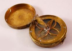 A 19TH CENTURY PERSIAN QAJAR BRASS PRAYER DIRECTION INDICATOR, of circular form with hinged cover,