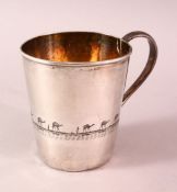 AN IRAQI SILVER AND NIELLO CUP, engraved with a band depicting a camel trek, 8cm high, weight 130g.