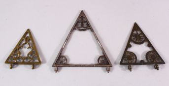 AN ISLAMIC STEEL BUILDING TRIANGLE, together with two others formed of brass, 17cm down to 11cm