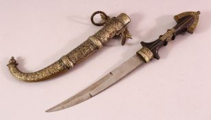 A LARGER NORTH AFRICAN METAL DRESS DAGGER, with a wooden handle, steel blade and decorated sheath,