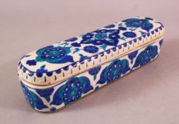 A TURKISH OTTOMAN KUTAHYA POTTERY PEN BOX & COVER, in blue and white floral decoration, 23cm