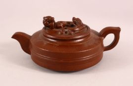 A CHINESE YIXING CLAY TEAPOT, with moulded beast like figures, the underside of the pot and lid with
