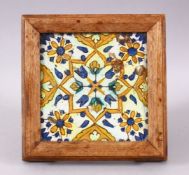 A 19TH / 20TH CENTURY TURKISH POTTERY TILE SECTION, housed within a wooden frame with feet,