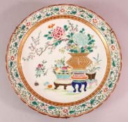 A JAPANESE PORCELAIN CHARGER, decorated with displays of ikebana, the verso with underglaze blue