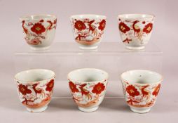 A SET OF SIX ARITA PORCELAIN CUPS, each painted with iron red bird amongst flowers, each approx. 7cm