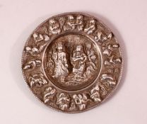 A FINE 19TH CENTURY BURMESE SILVER CIRCULAR DISH, embossed and chased with figures, 12cm diameter.
