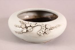 A CHINESE DEHUA PORCELAIN MOULDED BRUSH POT, with moulded prunus decoration, 21cm