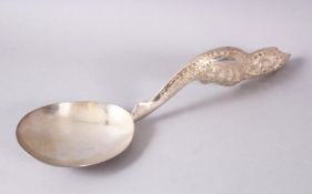 A LARGER BURMESE WHITE METAL MOULDED SERVING SPOON, the spoon with an embossed decorated floral