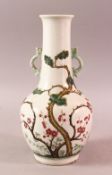 A CHINESE FAMILLE ROSE TWIN HANDLE PORCELAIN VASE, decorated to the body with native flora and