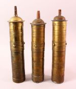 THREE 19TH CENTURY TURKISH BRASS CYLINDRICAL COFFEE GRINDERS, approx. 30cm high.