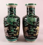 A LARGE PAIR OF CHINESE FAMILLE NOIR PORCELAIN DRAGON VASES, each vase with a black ground depicting