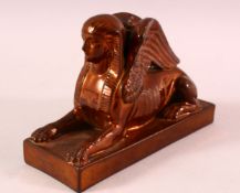 AN UNUSUAL COPPER LUSTRE DECORATED POTTERY MODEL OF SPHINX, impressed mark to base Wedgwood, 17cm