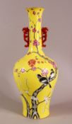 A CHINESE YELLOW GLAZED FAMILLE ROSE PORCELAIN VASE, decorated with birds in trees, with a mark