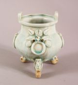 A CHINESE SONG STYLE QING BAI GLAZED CELADON TRIPLE FOOT POT, with twin handles and moulded