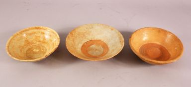 THREE EARLY CHINESE POTTERY BOWLS, of varying style and size (3)