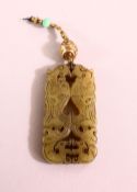 A CHINESE CARVED JADE PENDANT, twin dragon carving, 5cm