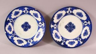 TWO 18TH CENTURY PERSIAN BLUE AND WHITE POTTERY DISHES, 21cm diameter.