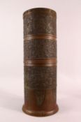 A LARGE JAPANESE CYLINDRICAL BRONZE RELIEF VASE, with profusely decorated sides of native flora,