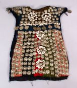 A 19TH CENTURY TURKISH SILVER ONLAID CHILDS DRESS, with silver roundel and shell applications.
