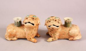 A PAIR OF 19TH / 20TH CENTURY CHINESE FAMILLE ROSE DOG CANDLESTICKS, each dog recumbent with the