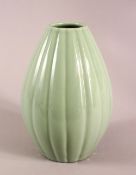 A CHINESE CELADON GLAZED RIBBED PORCELAIN VASE, the base with a six character mark, 24cm high,