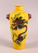 A CHINESE FAMILLE JAUNE TWIN HANDLE DRAGON PORCELAIN VASE, with twin lion dog mask handles and