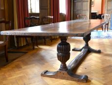 A GOOD OAK REFECTORY TABLE with two plank top, carved cup and cover supports and plain uniting