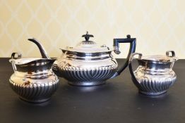 A SEMI FLUTED SILVER THREE PIECE TEA SET, comprising teapot, sugar basin and milk jug.London 1995.