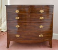 A GEORGIAN MAHOGANY BOWFRONT CHEST of two short and three long graduated drawers with oval brass