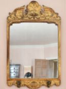 A GEORGE I GILT GESSO MIRROR. 3ft 3ins long x 2ft wide. Missing candle sconces.
