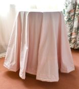 A SMALL CIRCULAR TABLE with fabric cover. 1ft 5ins diameter.