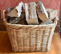 A TWO-HANDLED WICKER BASKET. 1ft 11ins long.