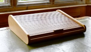 A DAVID LINLEY TAMBOUR FRONTED WRITING DESK, stamped LINLEY, with original box. 1ft 2ins x 1ft.