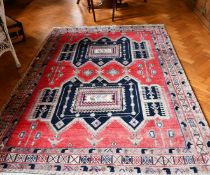 A PERSIAN WOOL RUG with two main medallions within a three-row border. 7ft x 4ft 8ins.