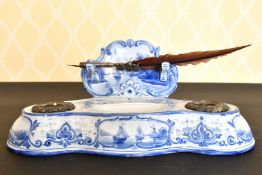 A BLUE AND WHITE POTTERY INKSTAND of DUTCH STYLE AND QUILL.