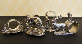 FIVE NOVELTY PLATE CUPID SERVIETTE RINGS.