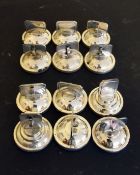 A SET OF TWELVE SMALL SILVER MENU HOLDERS.