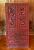 A GOOD CHINESE CARVED RED LACQUER STANDING CABINET, with double panel doors enclosing eight drawers,