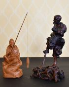 A CHINESE CARVED WOOD ONI on a stand, and A CHINESE FISHERMAN (2).