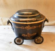 A VICTORIAN OVAL PONTYPOOL COAL BOX AND COVER on four wheels. 1ft 8ins.