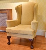 A GEORGE III STYLE MAHOGANY WING BACK ARMCHAIR, on carved cabriole legs ending in claw and ball