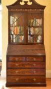 A GEORGE III DESIGN MAHOGANY BUREAU BOOKCASE, the top with swan neck pediment over glazed astragal